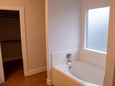 a white bath tub sitting in a bathroom