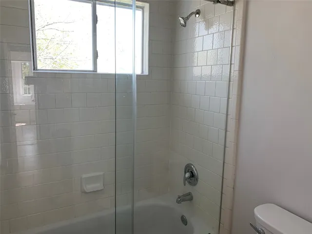 a bathroom with a bathtub and shower