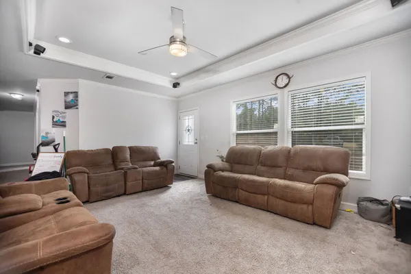 a living room with furniture and a chandelier
