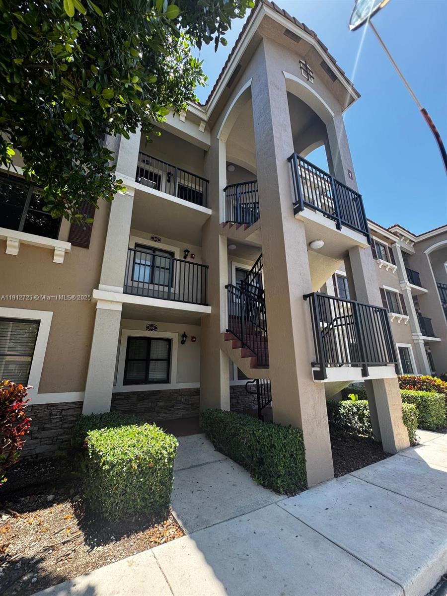 22621 Southwest 88th Place, Unit 3028 Cutler Bay, FL 33190 - Photo 2 of 18 a front view of a house with a yard