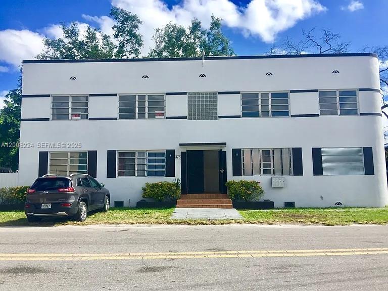 375 Southwest 19th Avenue, Unit 1 Miami, FL 33135 - Photo 1 of 29 a front view of a house with a garden and parking