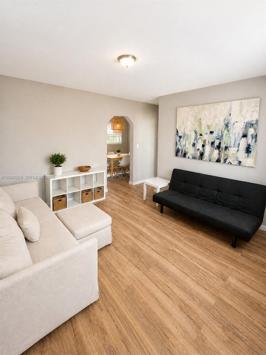 375 Southwest 19th Avenue, Unit 1 Miami, FL 33135 - Photo 5 of 29 a living room with furniture and a wooden floor