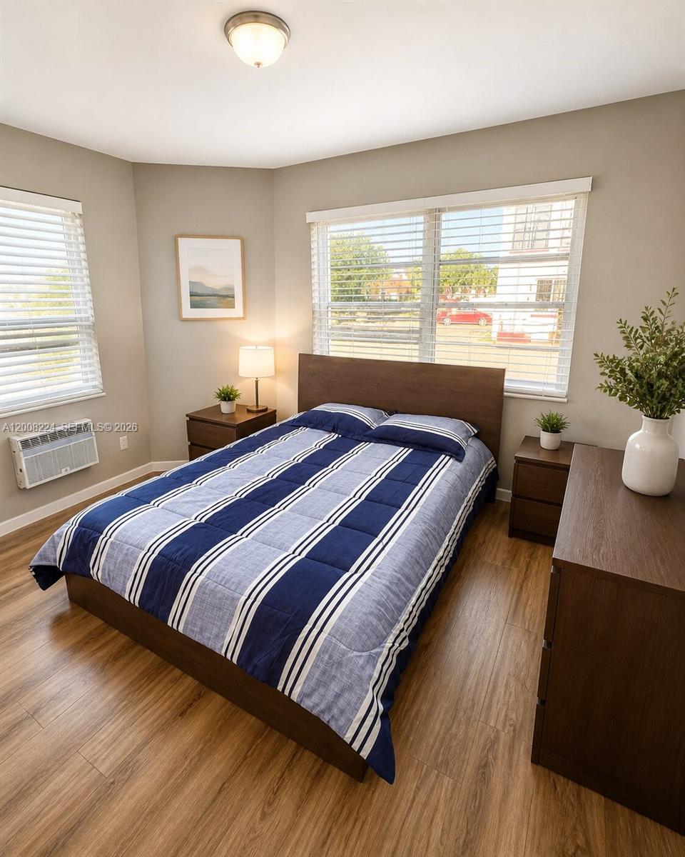 375 Southwest 19th Avenue, Unit 1 Miami, FL 33135 - Photo 9 of 29 a bedroom with a bed and a large window