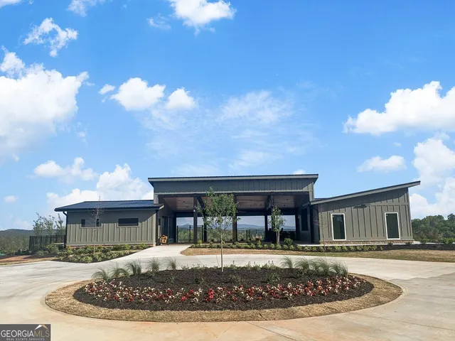 a view of a house with garden and sitting area