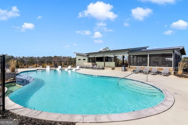 a swimming pool with outdoor seating and yard