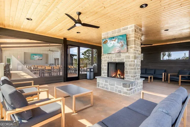 a living room with furniture a fireplace and a table