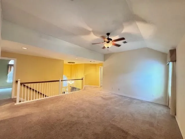 a view of a room with a ceiling fan