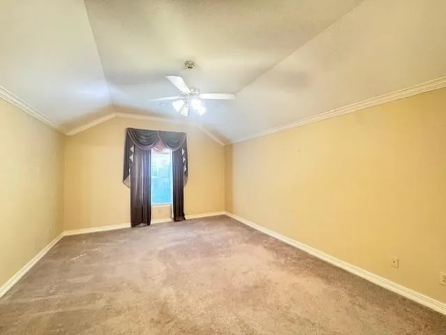 a view of an empty room with a chandelier fan
