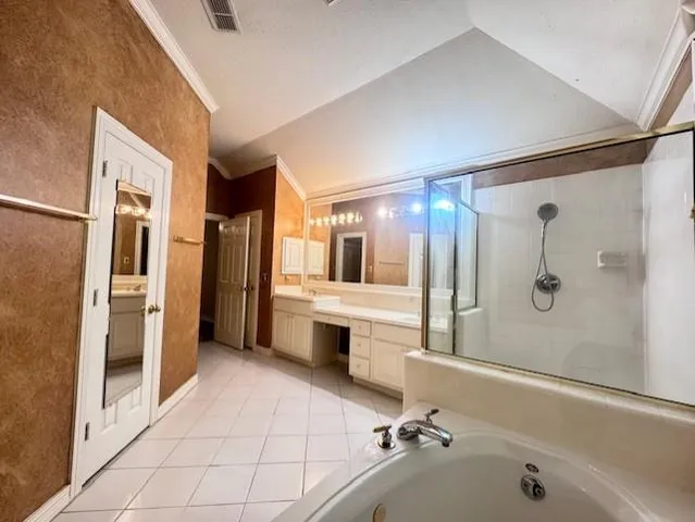 a bathroom with a tub a sink and a large mirror