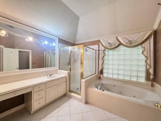 a spacious bathroom with a granite countertop tub sink shower and mirror