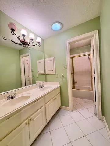 a bathroom with a sink a mirror and a shower