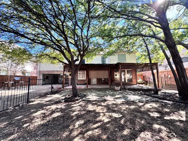 a view of a house with a tree in the forest