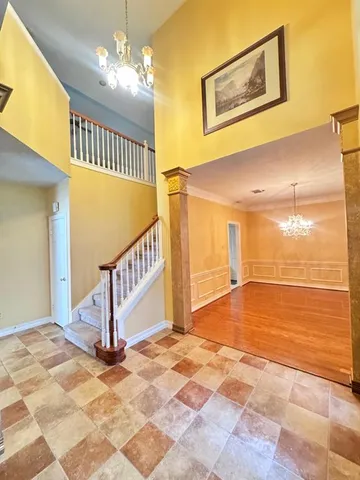 a view of an empty room with a chandelier