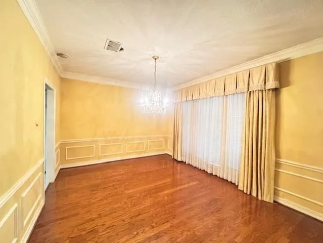 a view of a room with wooden floor and windows