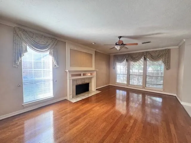 wooden floor in an empty room with a fireplace