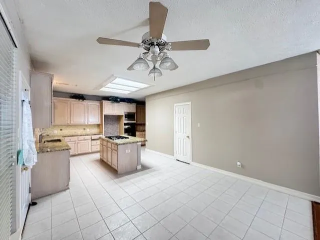 a kitchen with stainless steel appliances granite countertop a sink cabinets and stove top oven