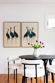 a view of a dining room with furniture and a potted plant