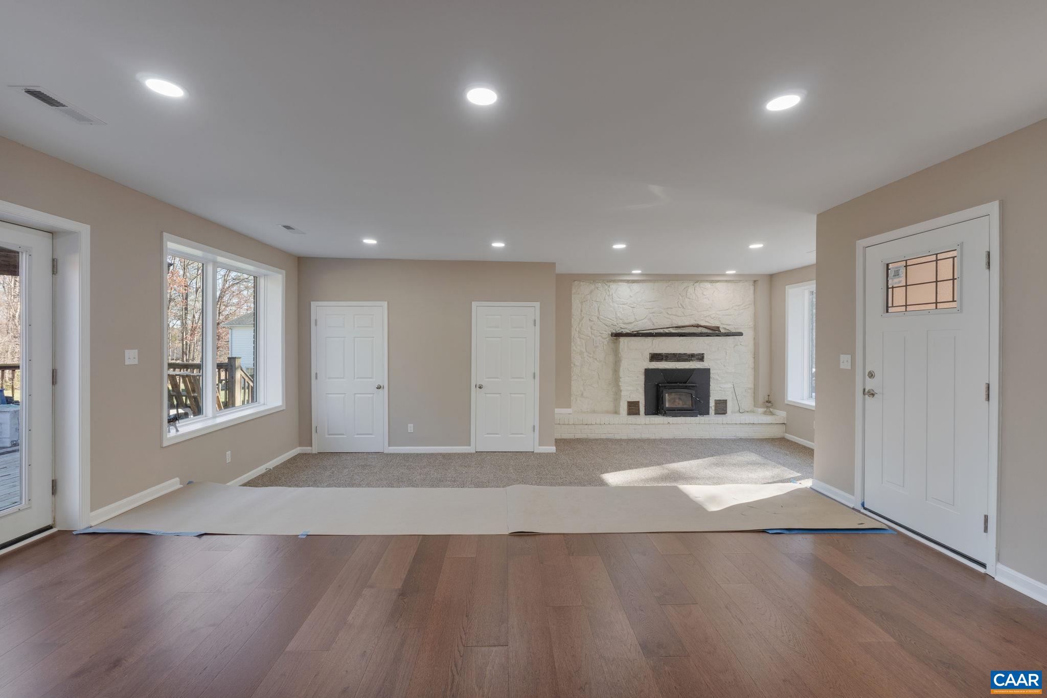 18503 Monrovia Road Orange, VA 22960 - Photo 12 of 39 an empty room with wooden floor and a fireplace