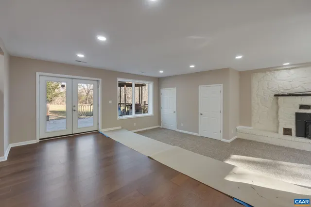 a kitchen with kitchen island granite countertop a sink a center island and stainless steel appliances