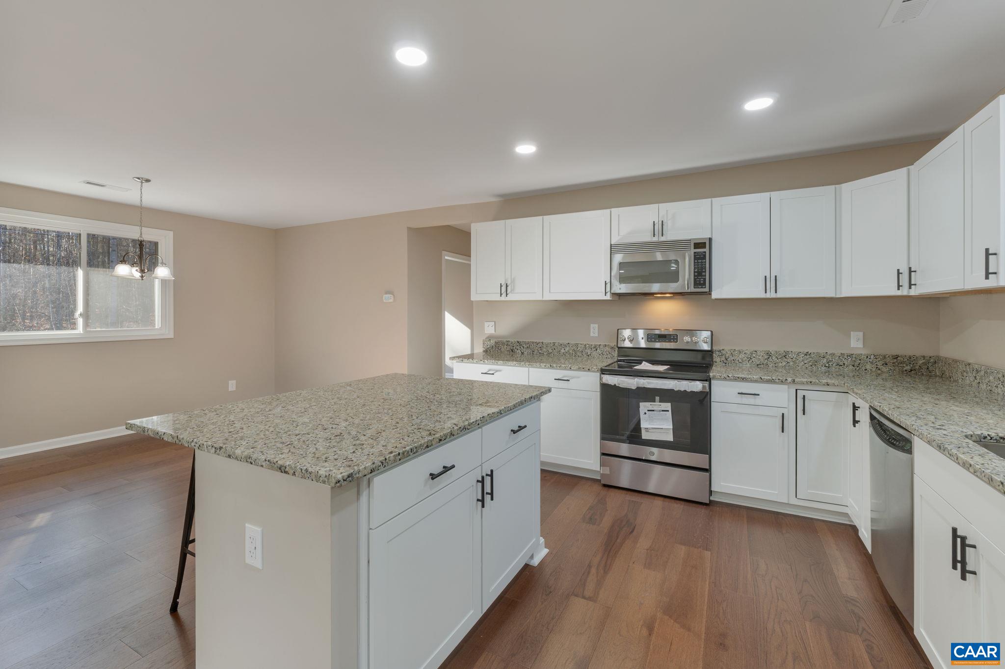 18503 Monrovia Road Orange, VA 22960 - Photo 20 of 39 a kitchen with granite countertop white cabinets and white appliances