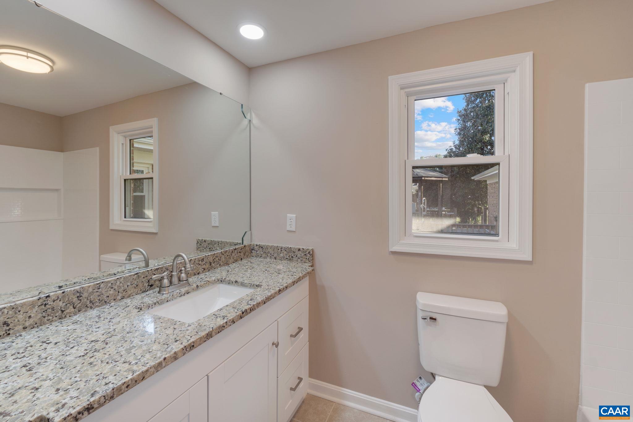 18503 Monrovia Road Orange, VA 22960 - Photo 26 of 39 a bathroom with a granite countertop toilet sink and mirror