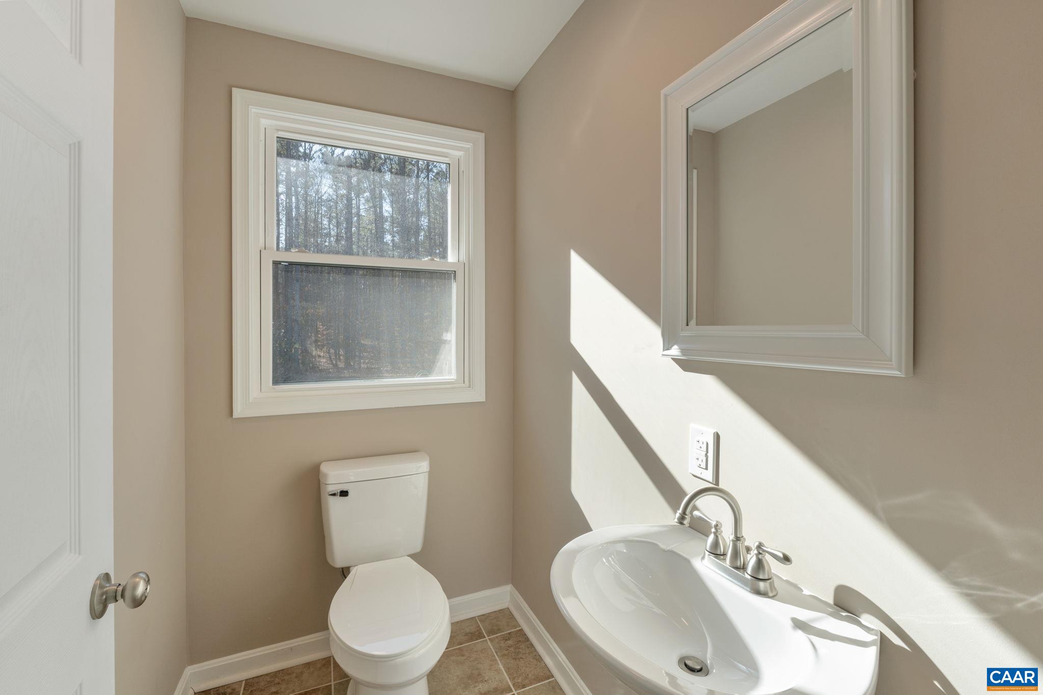 18503 Monrovia Road Orange, VA 22960 - Photo 28 of 39 a bathroom with a toilet a sink and mirror