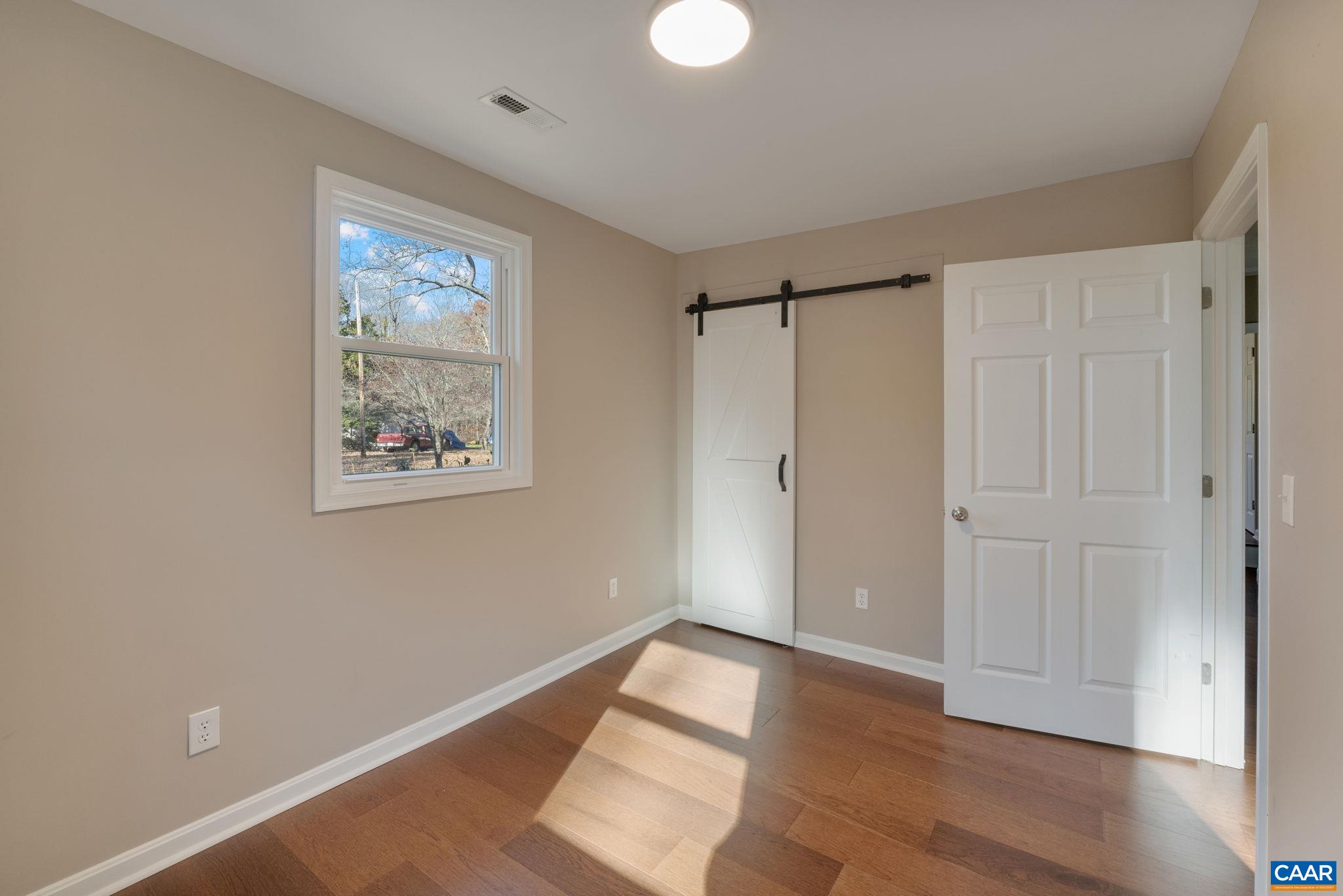18503 Monrovia Road Orange, VA 22960 - Photo 34 of 39 a view of empty room with wooden floor and fan
