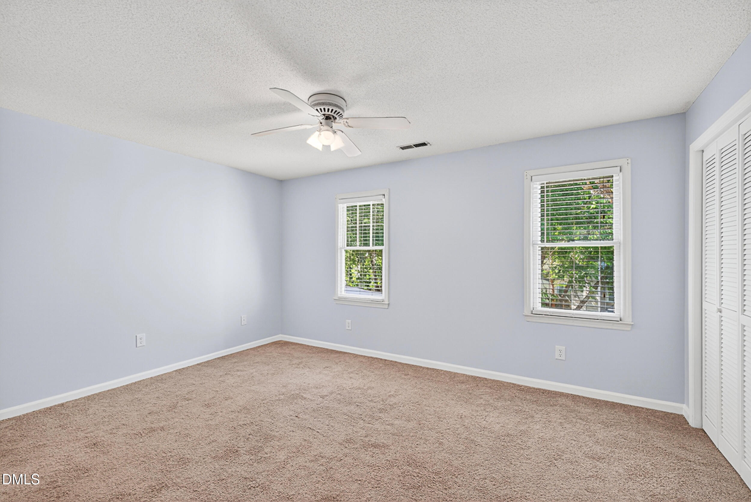 4617 Fawnbrook Circle Raleigh, NC 27612 - Photo 13 of 22 an empty room with windows and fan