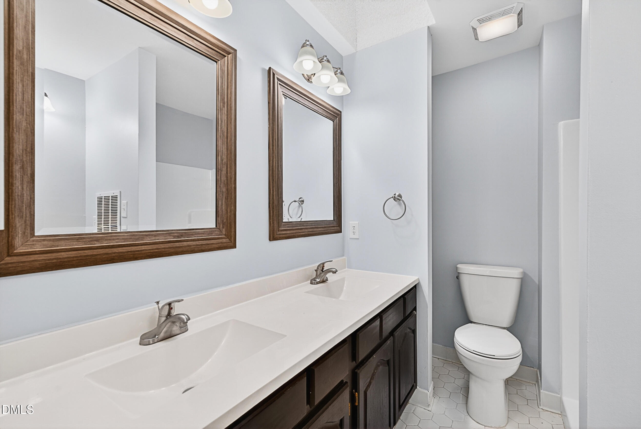 4617 Fawnbrook Circle Raleigh, NC 27612 - Photo 15 of 22 a bathroom with a toilet sink and mirror