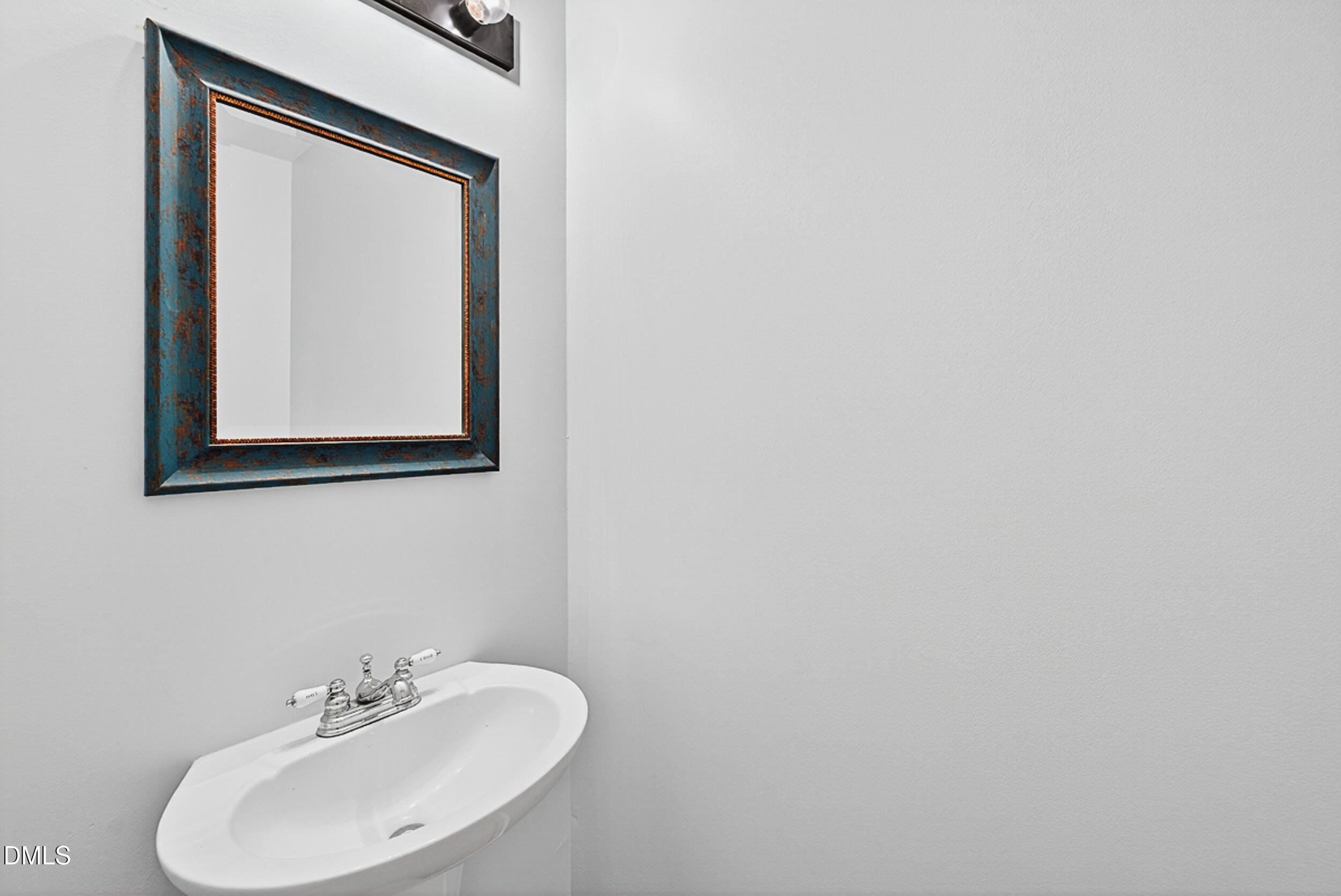 4617 Fawnbrook Circle Raleigh, NC 27612 - Photo 5 of 22 a bathroom with a sink and a mirror