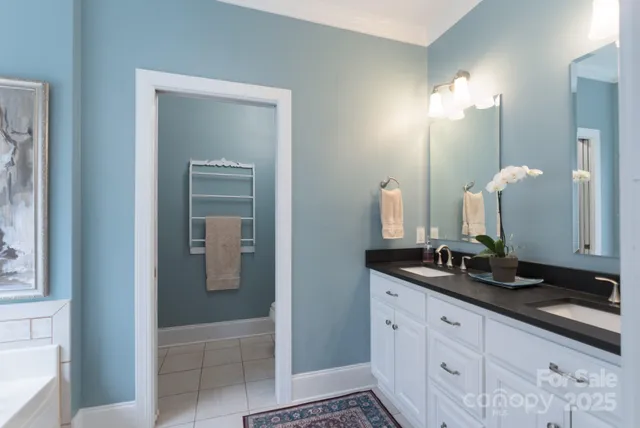 a bathroom with double sink and a mirror