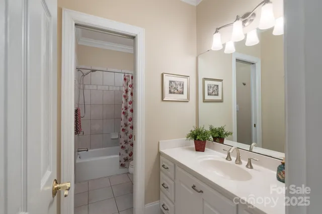 a bathroom with a sink vanity granite and shower