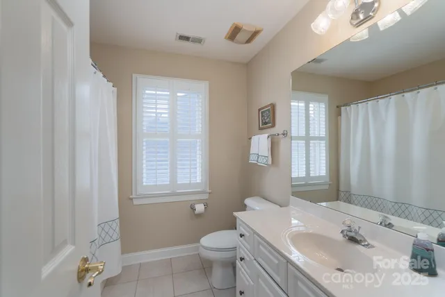 a bathroom with a sink toilet vanity and tub
