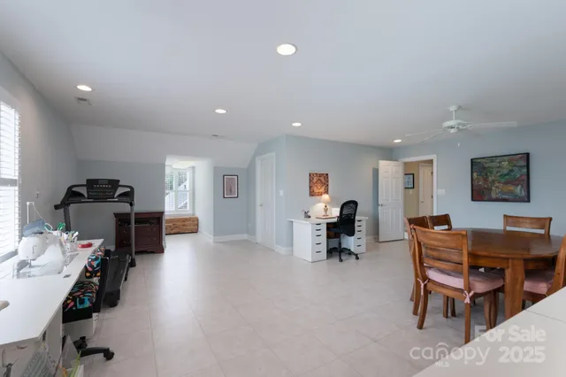 a living room with furniture a desk and chair with a workspace
