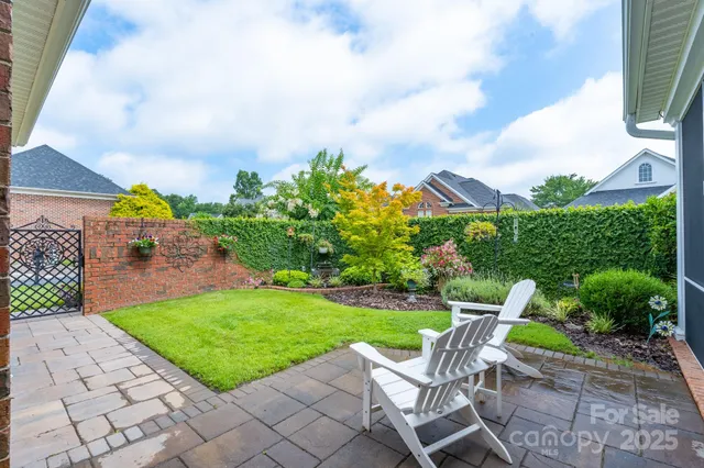 a view of yard with seating area and trees around