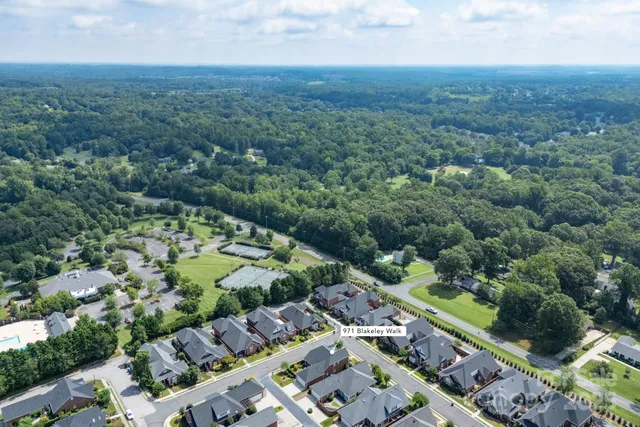 an aerial view of residential houses with outdoor space