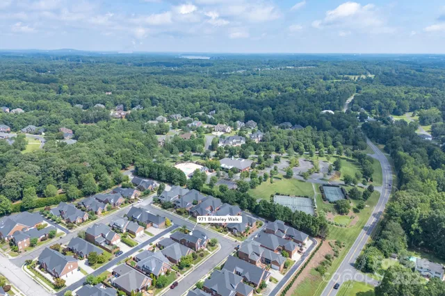 an aerial view of a house with a yard and outdoor seating