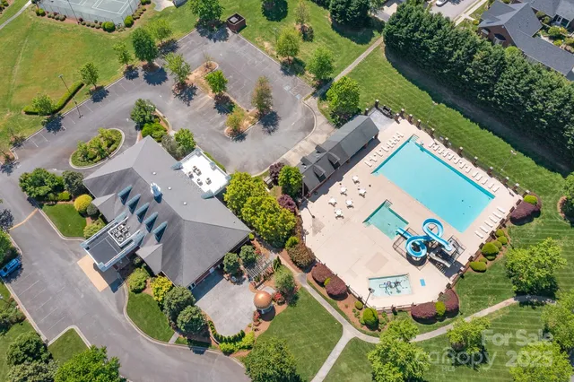an aerial view of a house with a garden and swimming pool