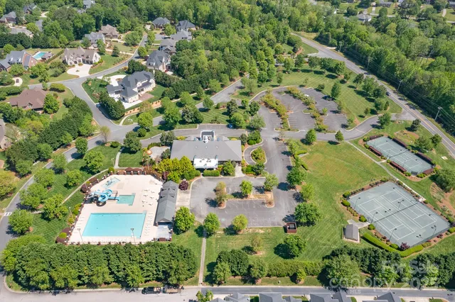 an aerial view of a house with a garden and a yard