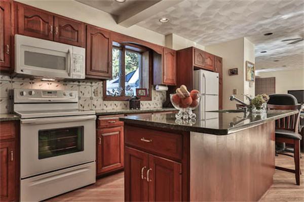 27 Bancroft Road Andover, MA 01810 - Photo 9 of 27 a kitchen with stainless steel appliances granite countertop a stove microwave and sink