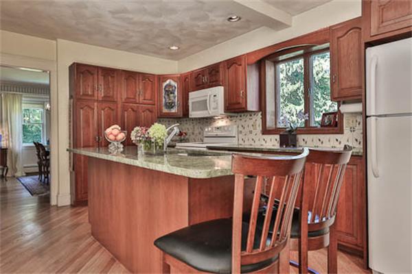 27 Bancroft Road Andover, MA 01810 - Photo 10 of 27 a kitchen with stainless steel appliances granite countertop a refrigerator a sink dishwasher a dining table and chairs with wooden floor