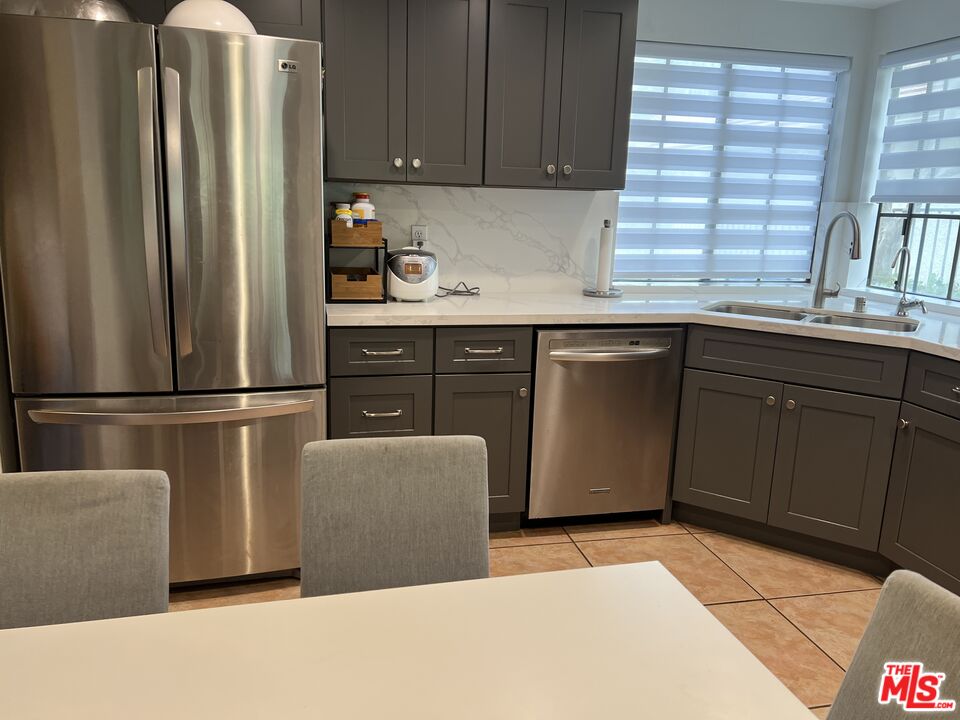 19528 Eagle Ridge Lane Porter Ranch, CA 91326 - Photo 5 of 20 a kitchen with stainless steel appliances granite countertop a refrigerator and a sink