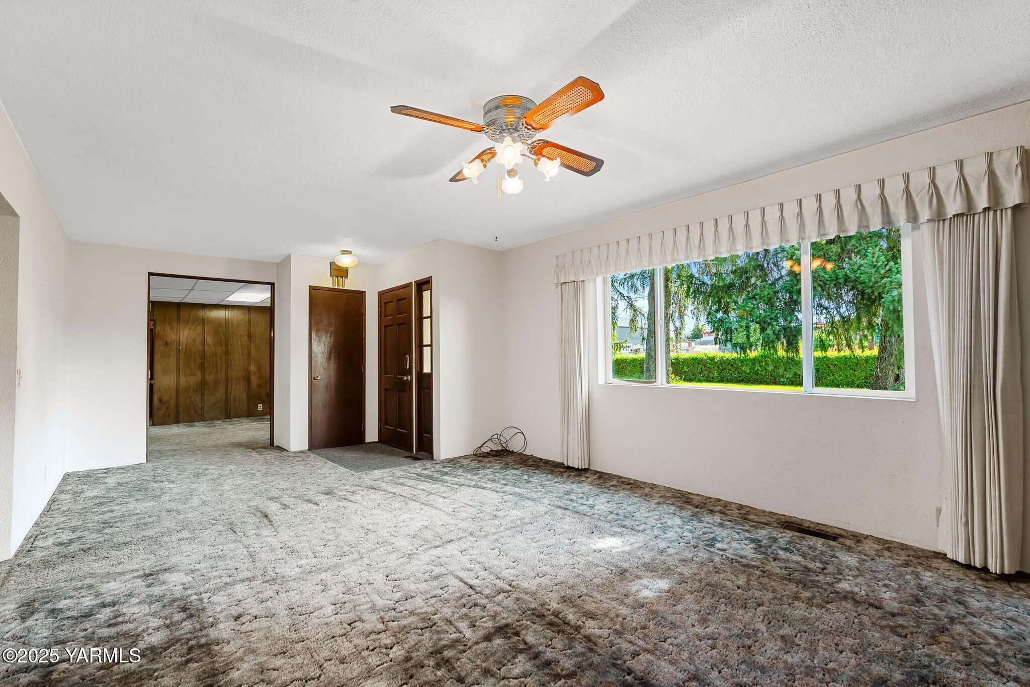 2006 Ekelman Road Yakima, WA 98901 - Photo 4 of 27 wooden floor in an empty room with a window