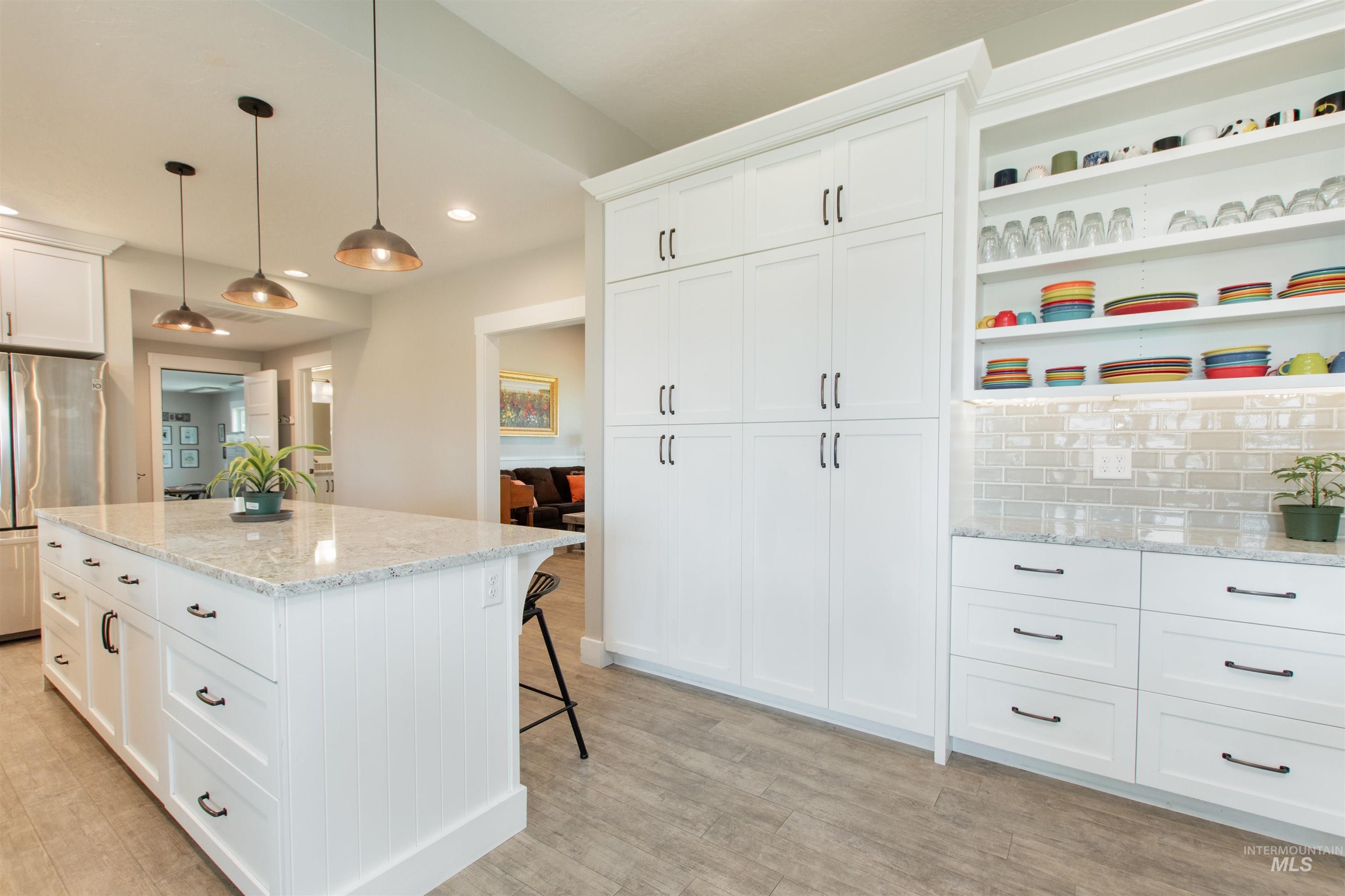 12369 Deer Flat Road Nampa, ID 83686 - Photo 16 of 50 Living area featuring light gray walls with wainscoting, wood-finish flooring, and recessed lighting
