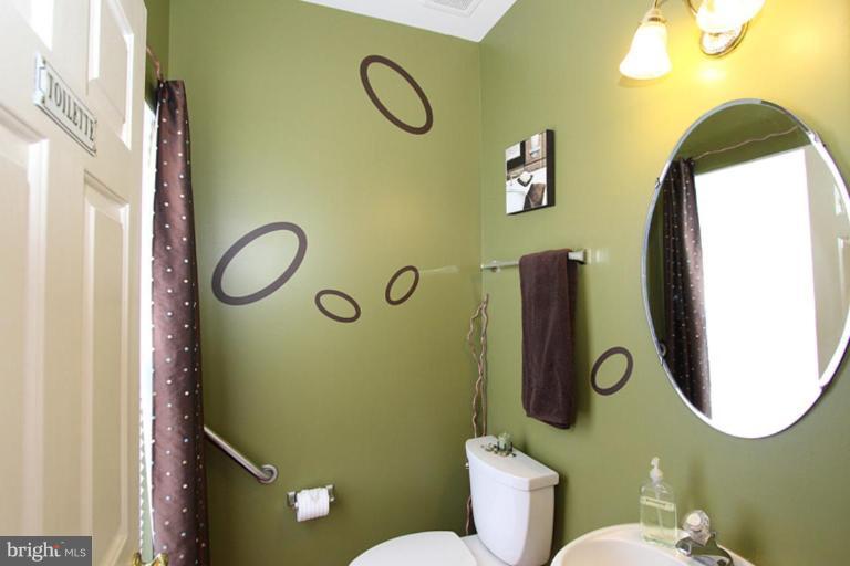 14208 Autumn Gold Road Boyds, MD 20841 - Photo 3 of 21 a bathroom with a toilet mirror and vanity
