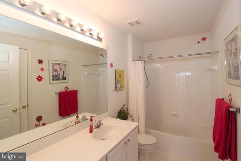14208 Autumn Gold Road Boyds, MD 20841 - Photo 9 of 21 a bathroom with a sink vanity granite tub shower and a mirror