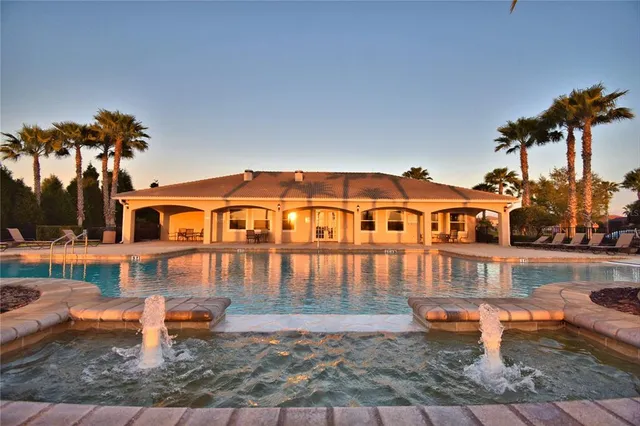 a swimming pool with outdoor seating and garden