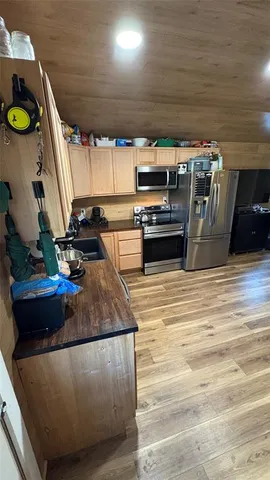 a kitchen with kitchen island a stove and a wooden floors