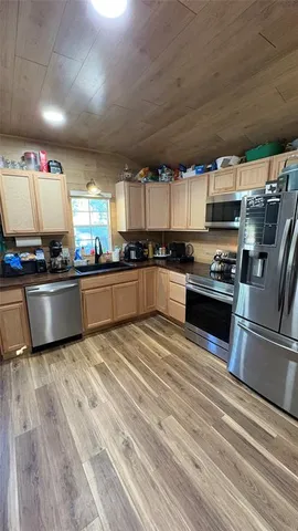 a kitchen with stainless steel appliances granite countertop a stove sink and cabinets