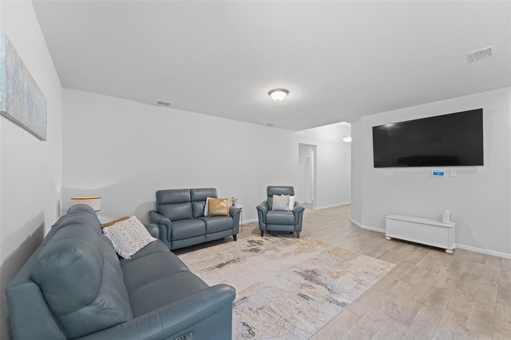 9020 Ridgeriver Way Fort Worth, TX 76131 - Photo 8 of 26 a living room with furniture and a flat screen tv